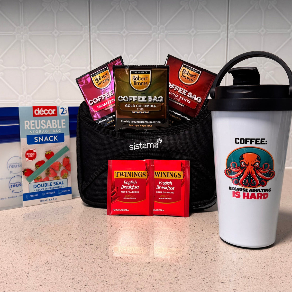 Coffee-themed products including a tumbler, coffee bags, and snacks on a kitchen counter.