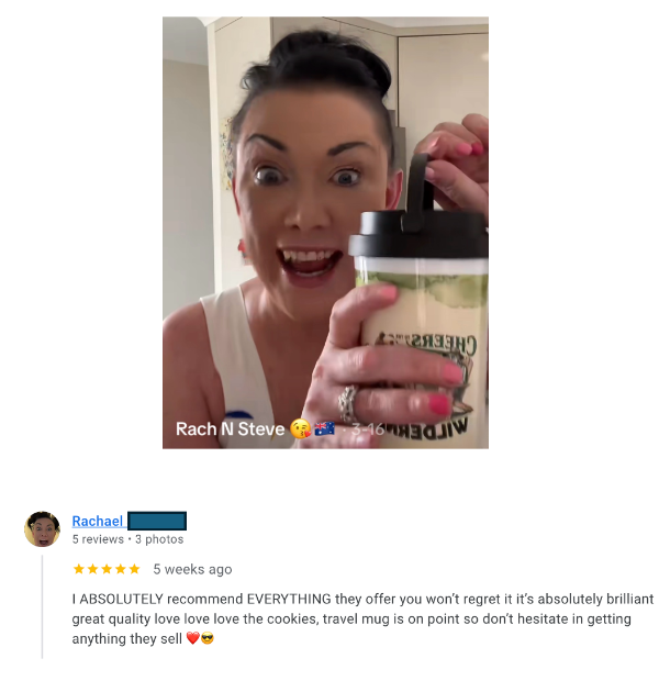 Person holding a travel mug with a review on a social media platform